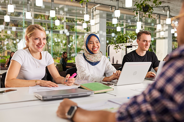 4 students at a table in a UQ learning space